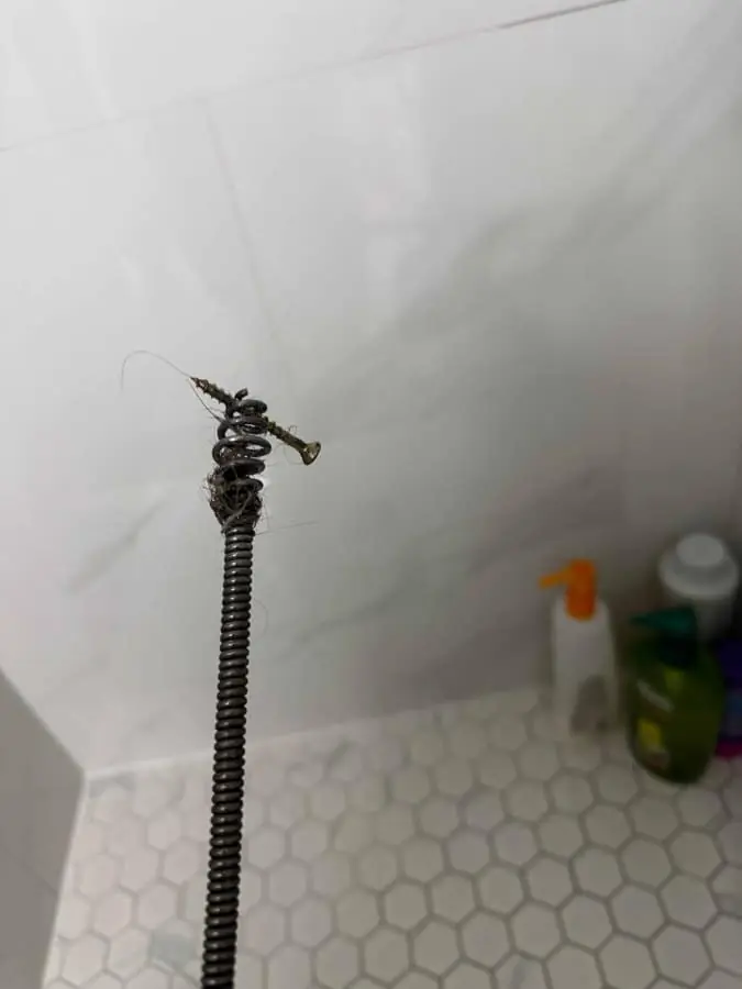 Drain auger pulled from an older clay lateral near a Cookstown kitchen sink — Quick Plumbing & Drain, serving Cookstown, ON