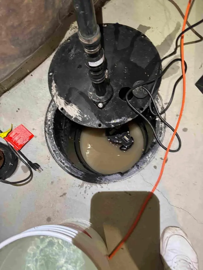 Sump pump basin and discharge line installed in a basement mechanical area — Quick Plumbing & Drain, serving Schomberg, ON