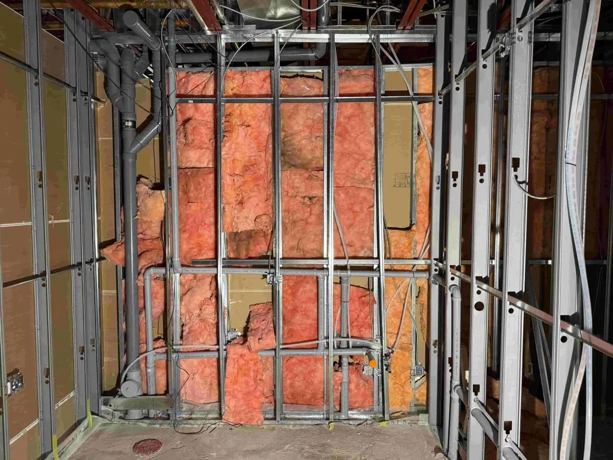Plumbing rough-in through steel-stud framing on a commercial build-out — Quick Plumbing & Drain, serving Creemore, ON